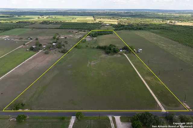 an aerial view of a house with a lake view