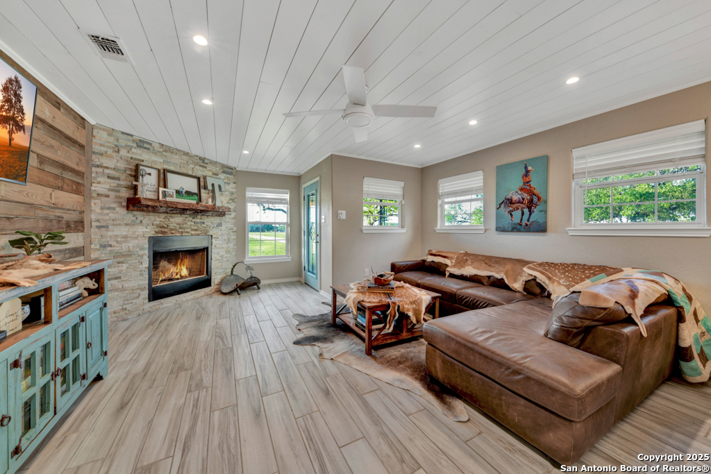 15592 Miller Road St. Hedwig, TX 78152 - Photo 6 of 47 a living room with furniture and a fireplace