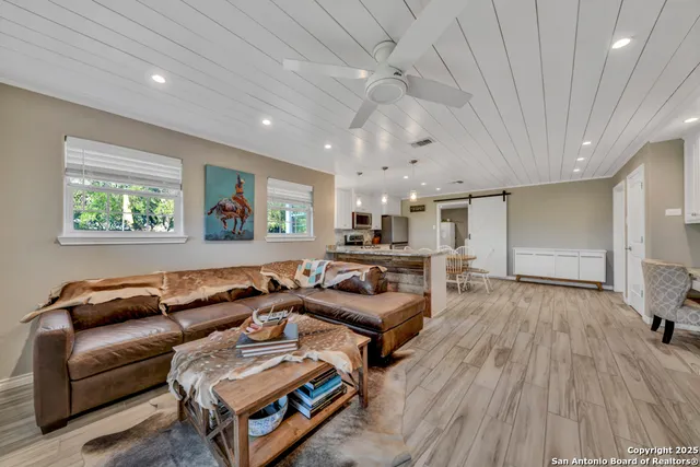 a kitchen with granite countertop white cabinets and stainless steel appliances