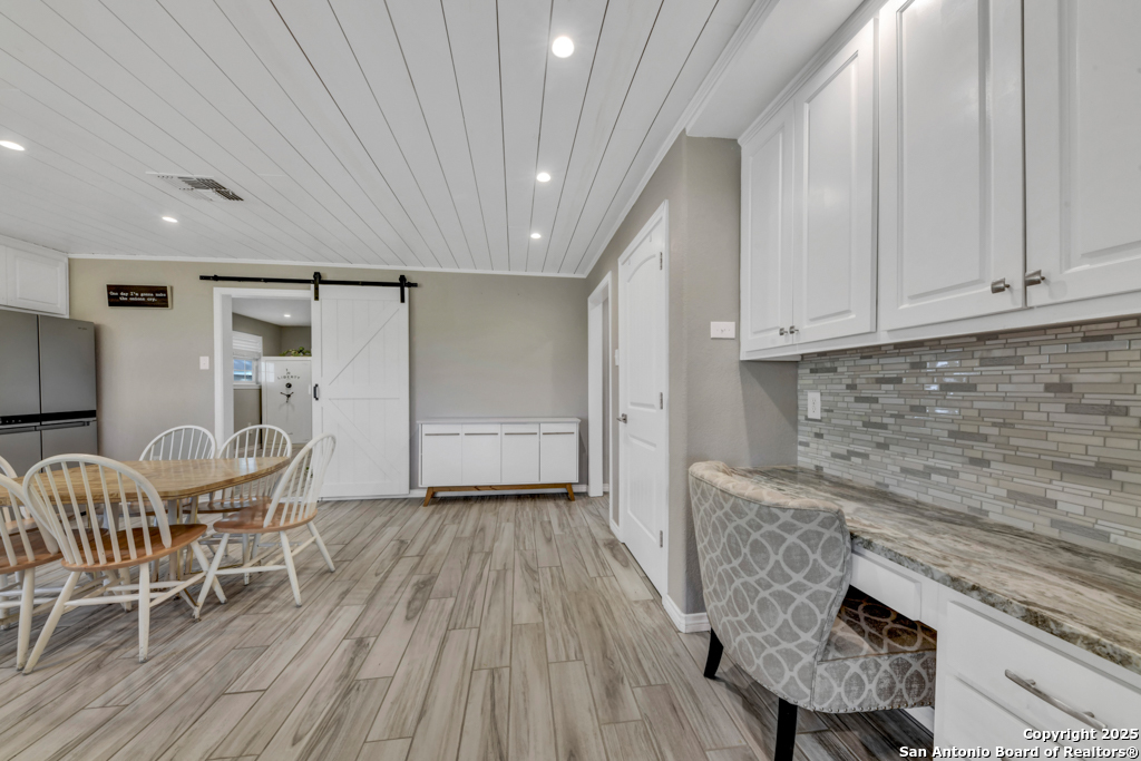 15592 Miller Road St. Hedwig, TX 78152 - Photo 9 of 47 a kitchen with granite countertop white cabinets and stainless steel appliances