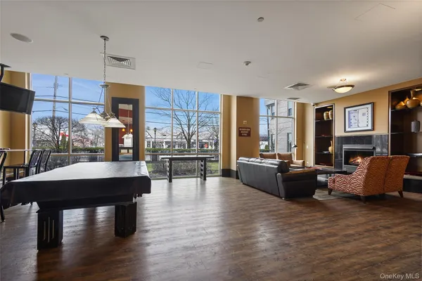 a living room with fireplace furniture and a wooden floor
