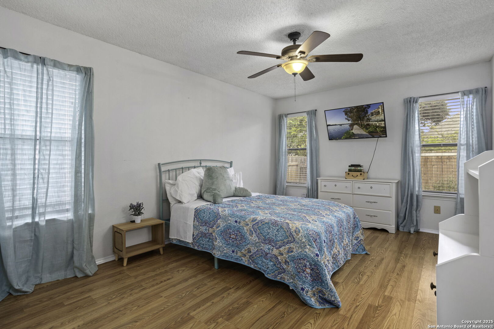 4447 Brushy Hill San Antonio, TX 78217 - Photo 9 of 13 a bedroom with a bed and wooden floor