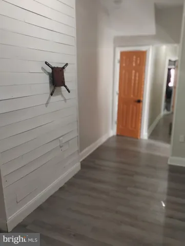 a view of a room with wooden floor
