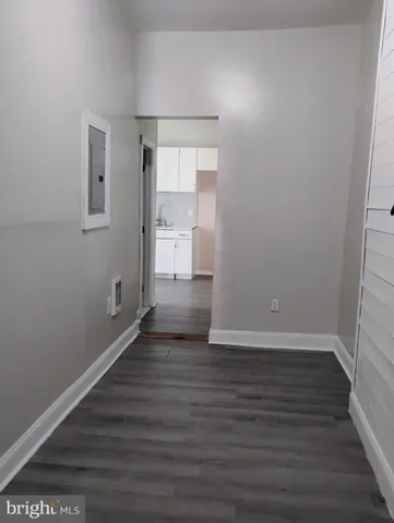 a view of a room with wooden floor and window