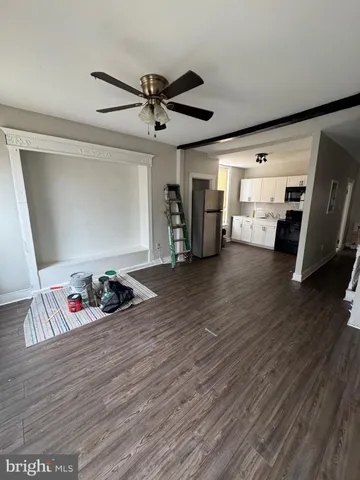 an empty room with wooden floor and closet