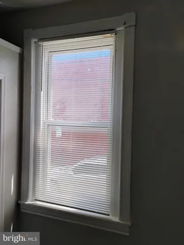 an empty room with wooden floor and a window