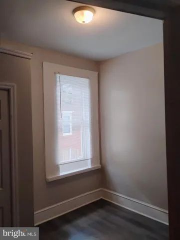 a kitchen with a refrigerator and a stove top oven