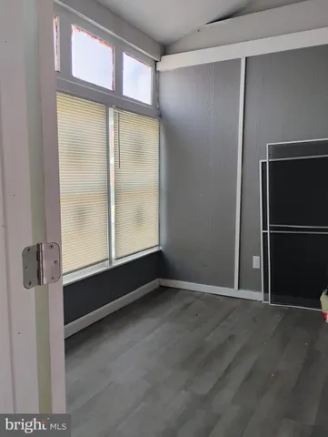 an empty room with wooden floor