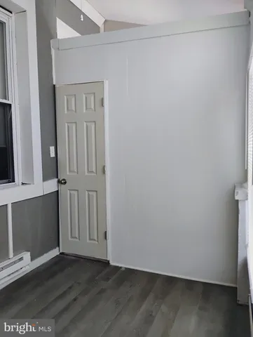 a kitchen with granite countertop a stove top oven a sink dishwasher and a refrigerator with wooden floor