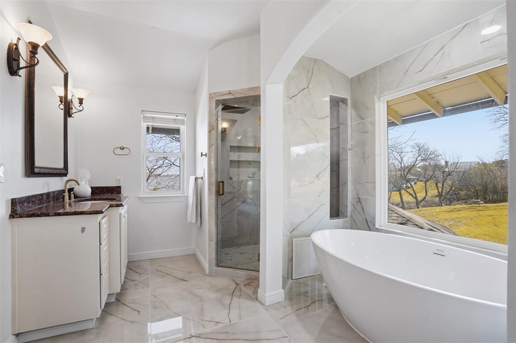 13280 Beach Club Road The Colony, TX 75056 - Photo 16 of 40 a bathroom with a granite countertop sink a bathtub and a shower