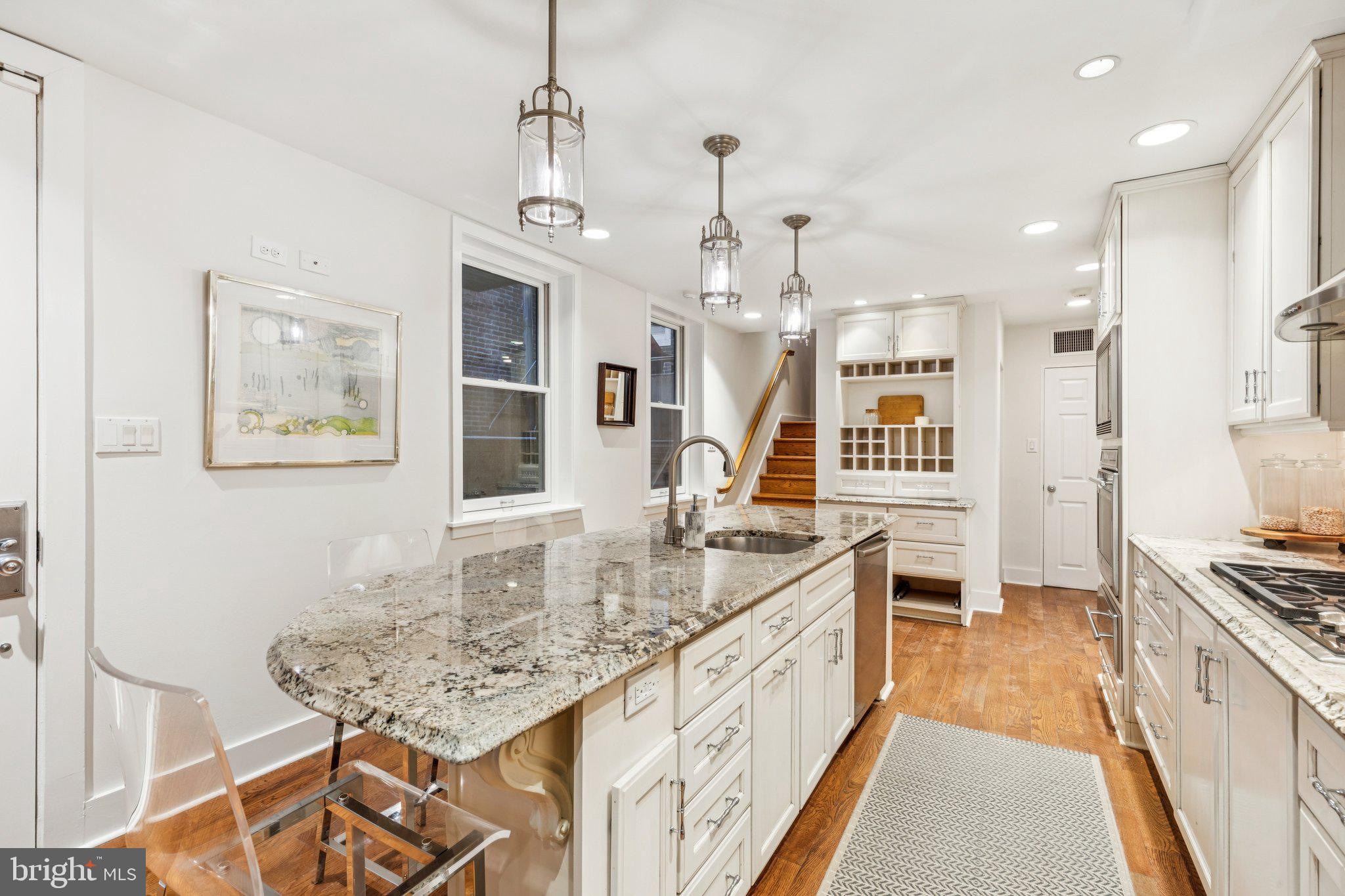 2221 Locust Street Philadelphia, PA 19103 - Photo 15 of 70 a spacious kitchen with stainless steel appliances granite countertop a sink stove and refrigerator