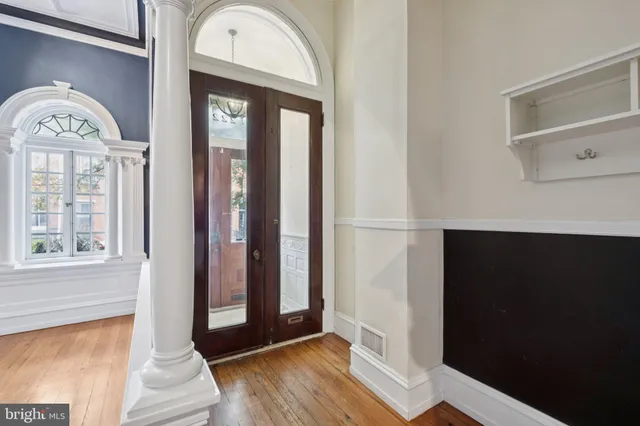 a view of a livingroom with wooden floor and a window