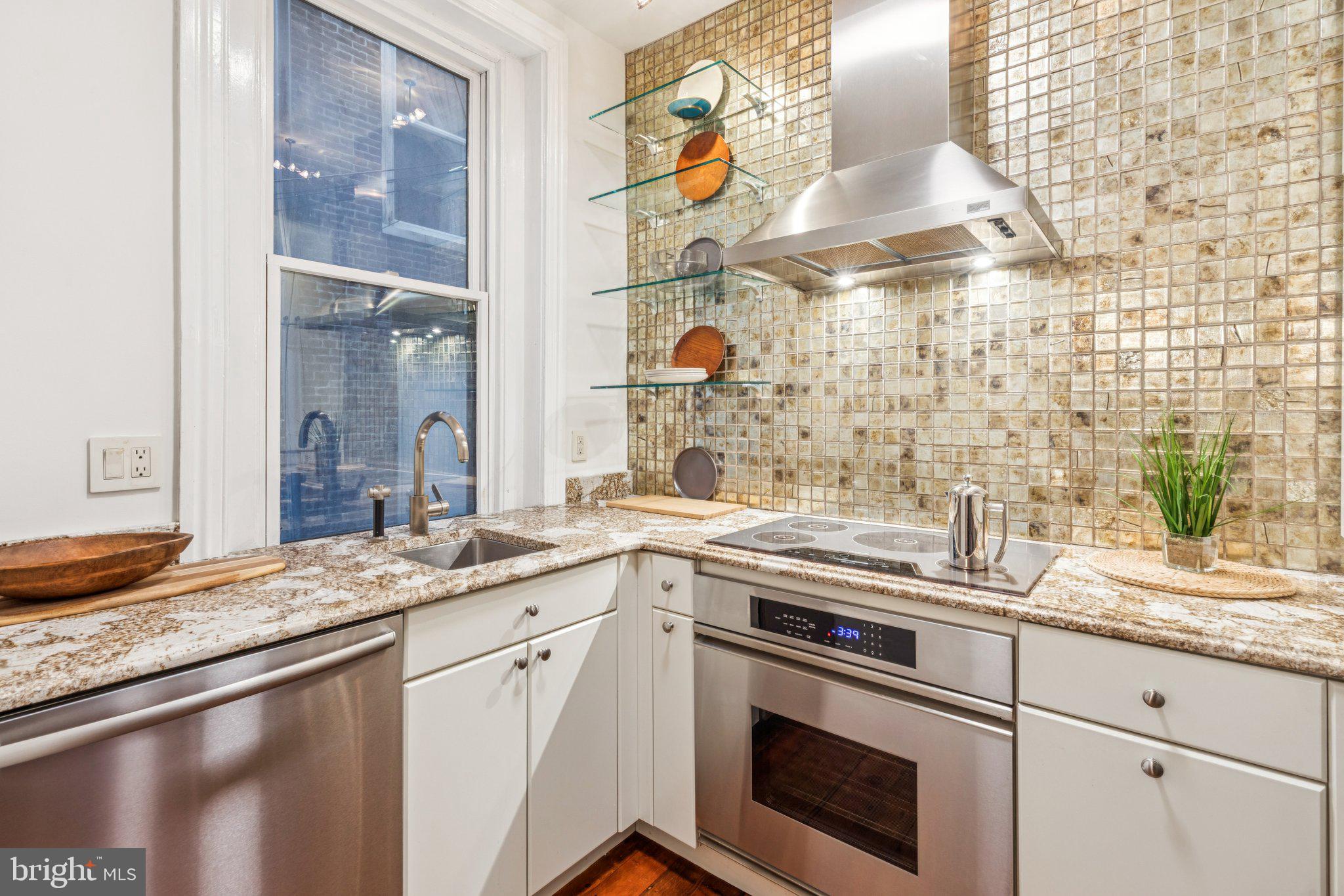 2221 Locust Street Philadelphia, PA 19103 - Photo 30 of 70 a kitchen with a sink stove and cabinets