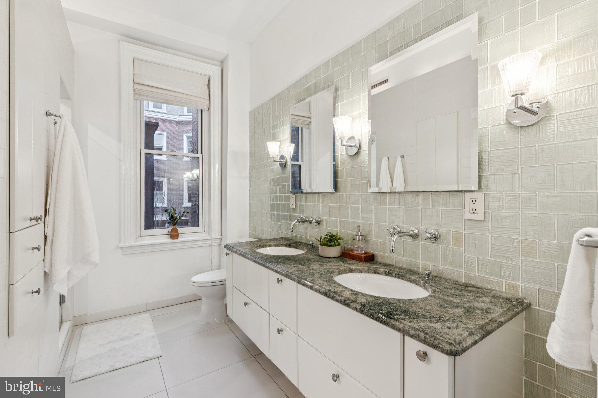 2221 Locust Street Philadelphia, PA 19103 - Photo 46 of 70 a bathroom with a granite countertop sink and a mirror