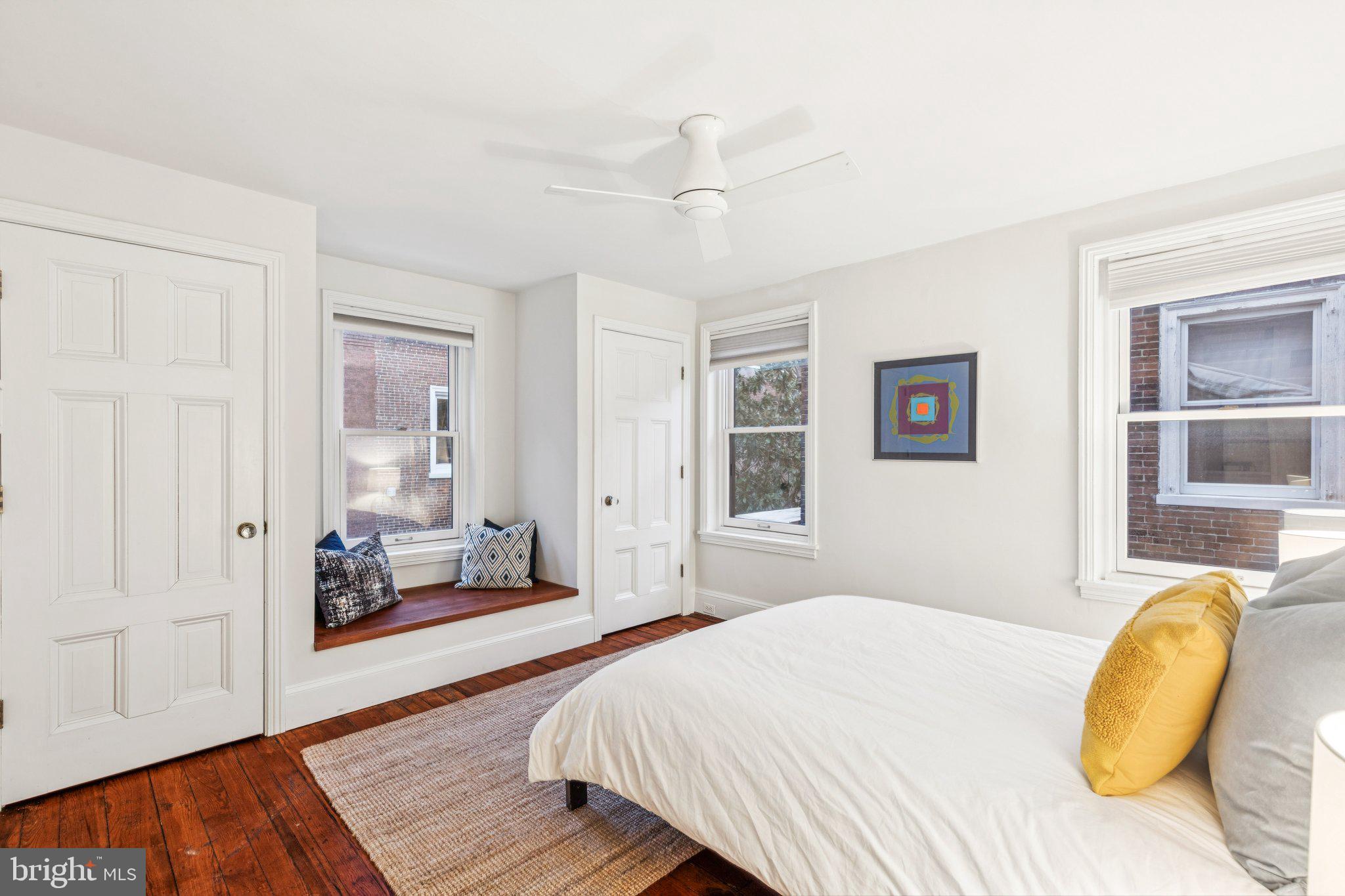 2221 Locust Street Philadelphia, PA 19103 - Photo 50 of 70 a bedroom with a bed and wooden floor