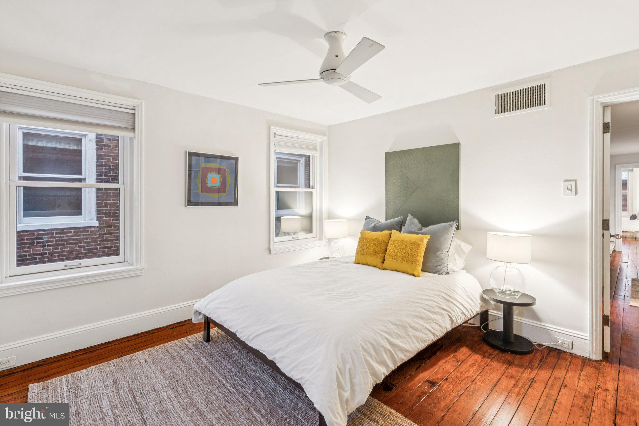 2221 Locust Street Philadelphia, PA 19103 - Photo 51 of 70 a bedroom with a bed and wooden floor