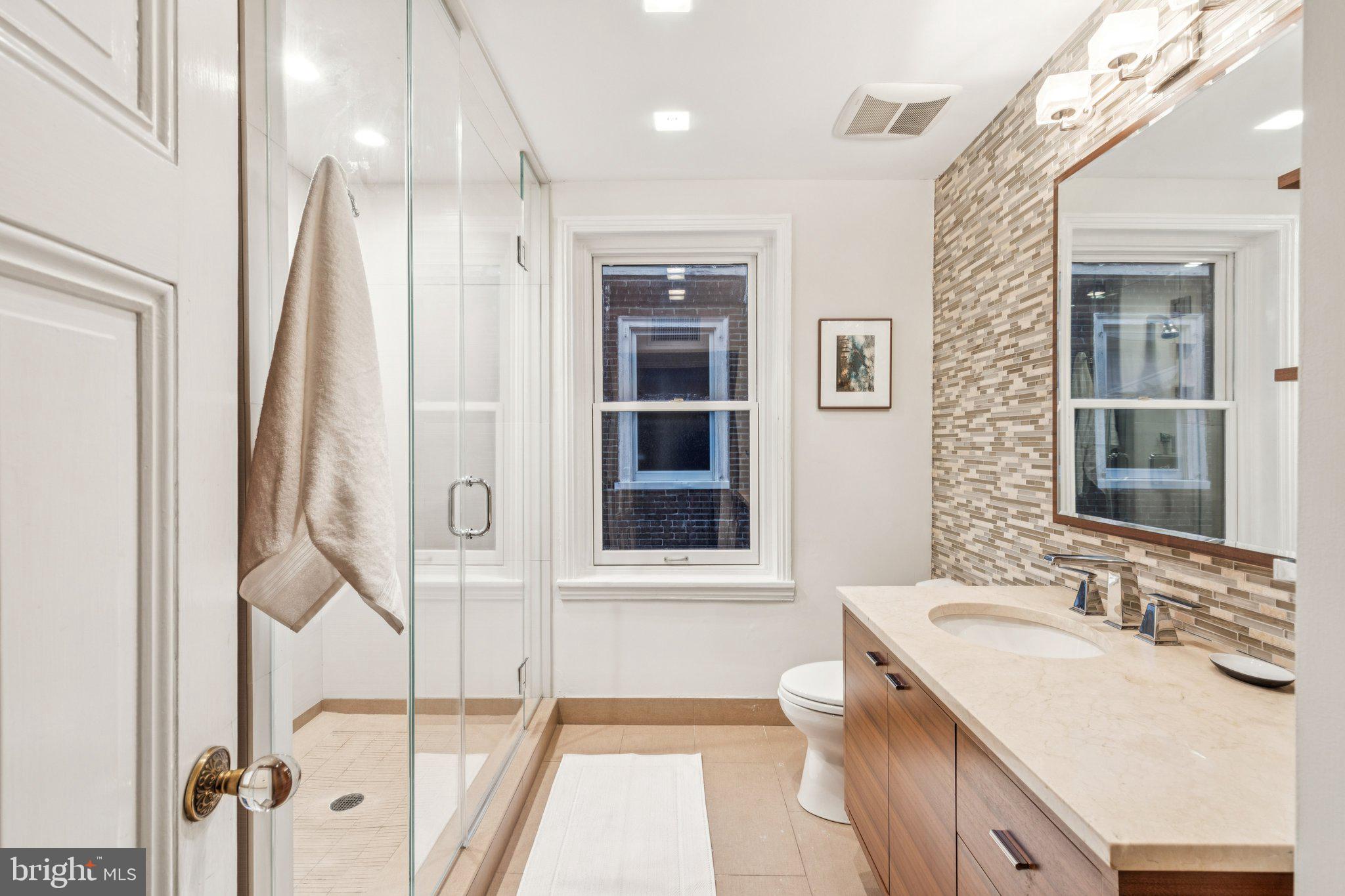 2221 Locust Street Philadelphia, PA 19103 - Photo 53 of 70 a bathroom with a sink a vanity and a mirror
