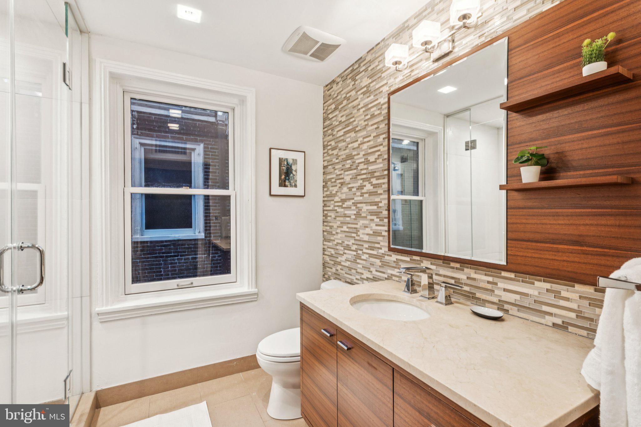 2221 Locust Street Philadelphia, PA 19103 - Photo 54 of 70 a bathroom with a sink vanity granite toilet and a mirror