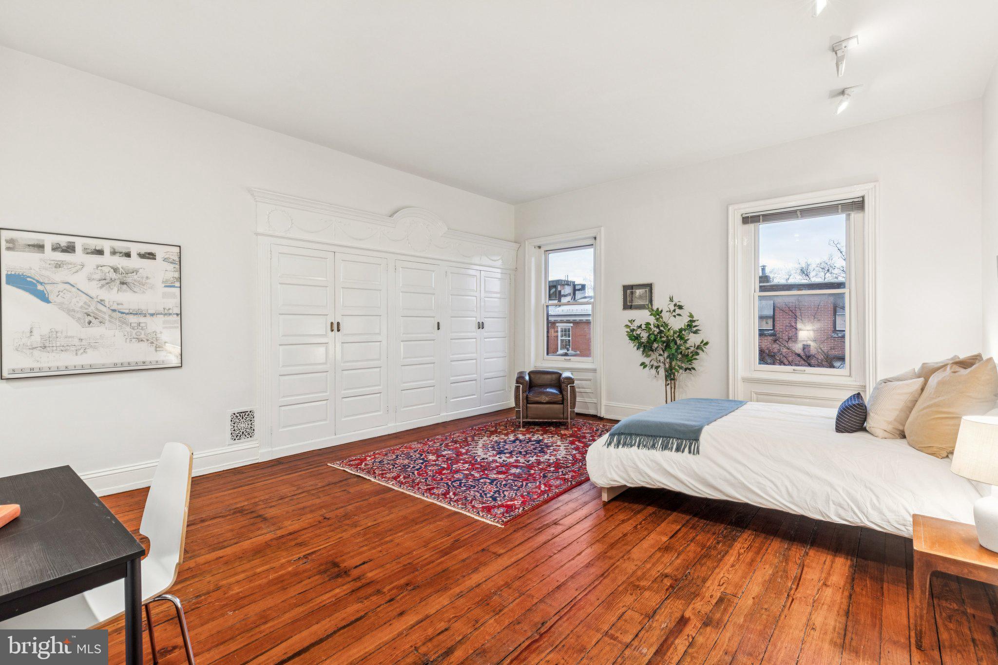 2221 Locust Street Philadelphia, PA 19103 - Photo 56 of 70 a bedroom with a bed and a table in it