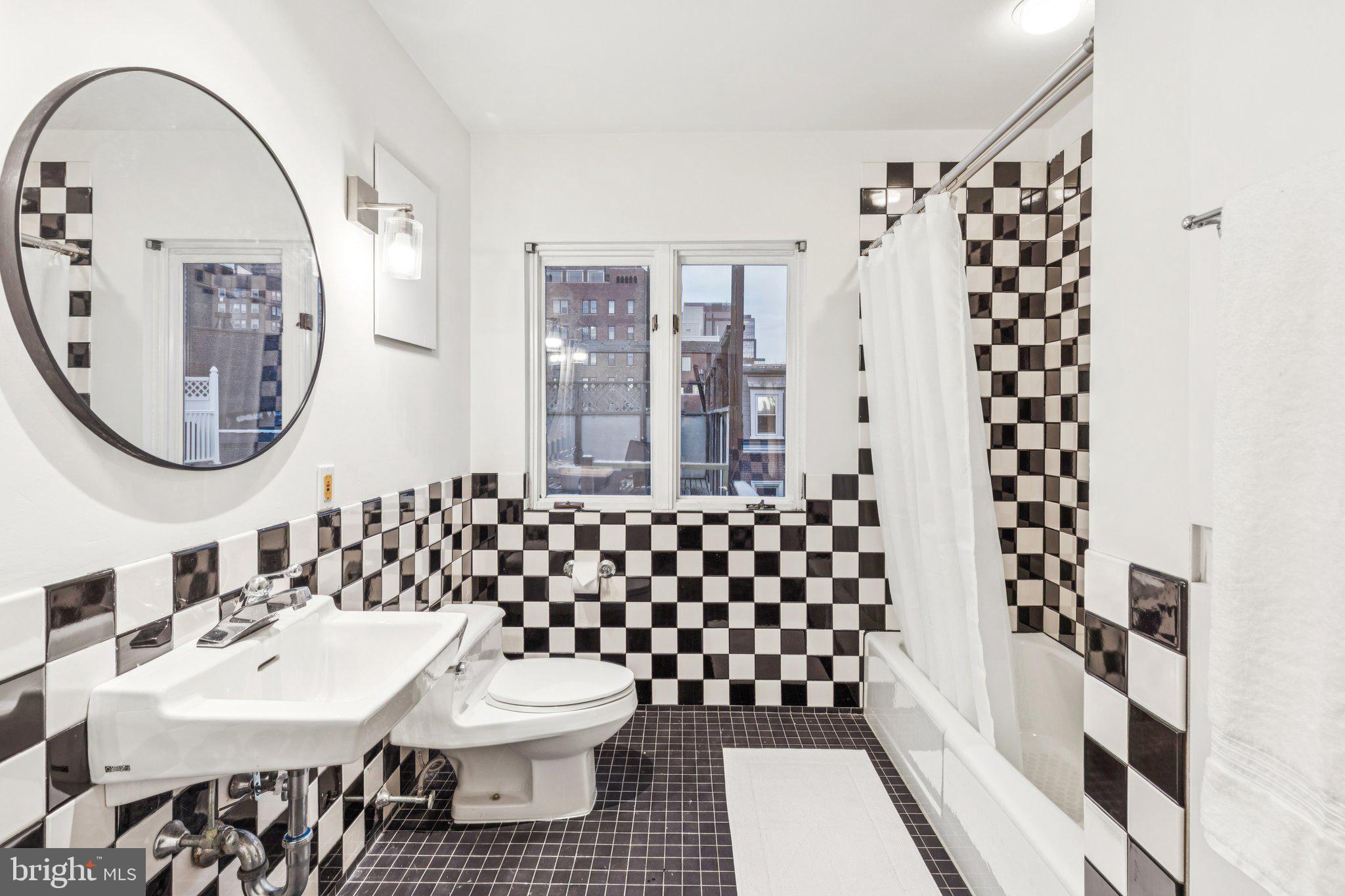 2221 Locust Street Philadelphia, PA 19103 - Photo 65 of 70 a bathroom with a sink toilet and a mirror