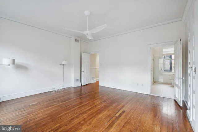 a view of an empty room with wooden floor