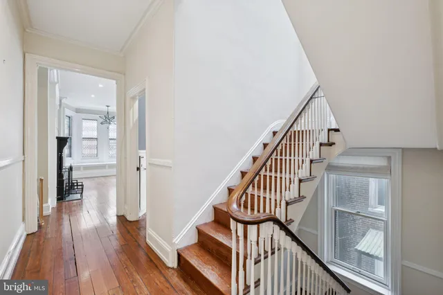 a view of entryway and hall with wooden floor