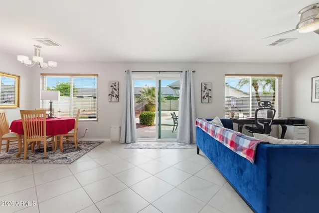 a living room with furniture and a mirror