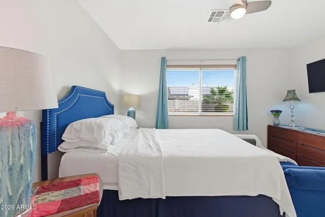 a bathroom with a granite countertop sink a toilet a mirror and shower