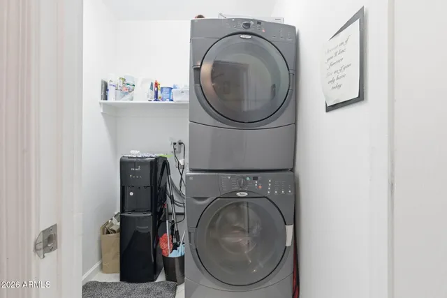 a view of a patio with table and chairs under an umbrella