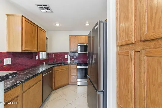 a kitchen with stainless steel appliances granite countertop cabinets and a granite counter tops