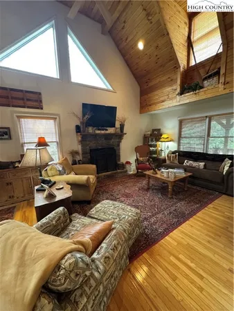 a living room with furniture kitchen view and a window