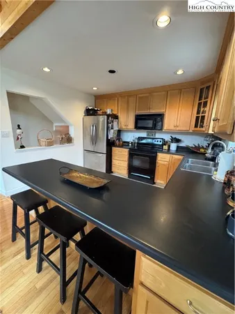 a kitchen with stainless steel appliances kitchen island granite countertop a sink and cabinets