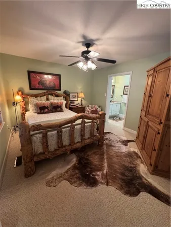 a bedroom with bed and a chandelier