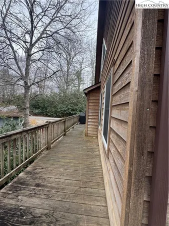 a view of balcony with wooden floor and fence