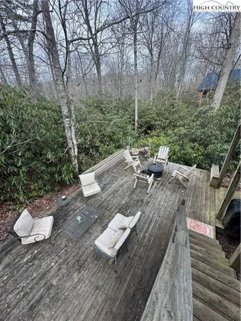 a view of a deck with furniture and a yard