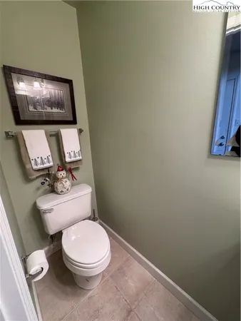 a white toilet sitting next to a small bathroom