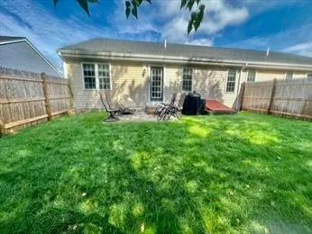 a view of a house with backyard sitting area and garden