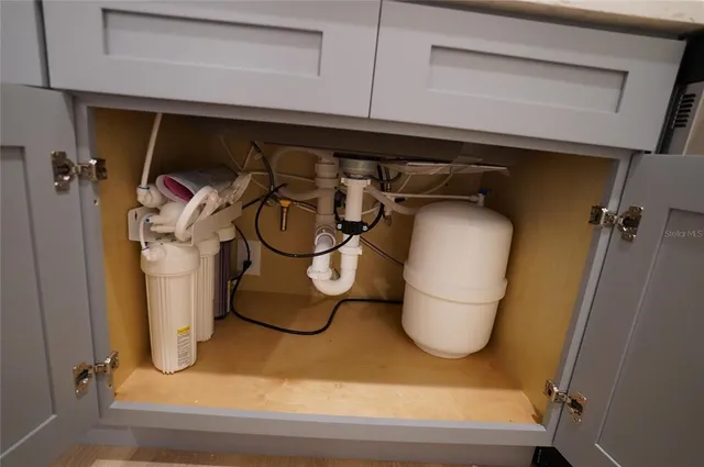 a bathroom with a washing machine and a shower