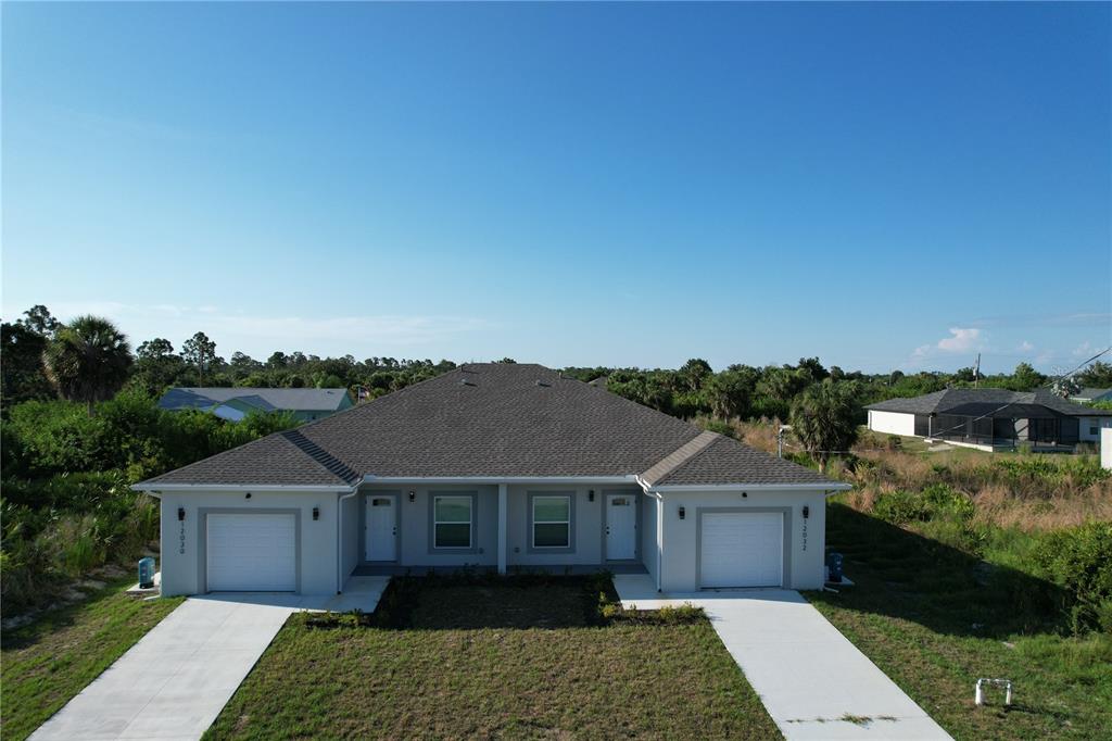 12032 Tetzel Avenue Port Charlotte, FL 33981 - Photo 26 of 32 front view of a house with a yard