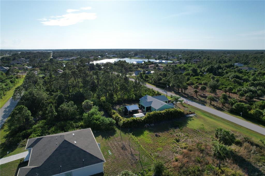 12032 Tetzel Avenue Port Charlotte, FL 33981 - Photo 31 of 32 an aerial view of residential houses with outdoor space and trees