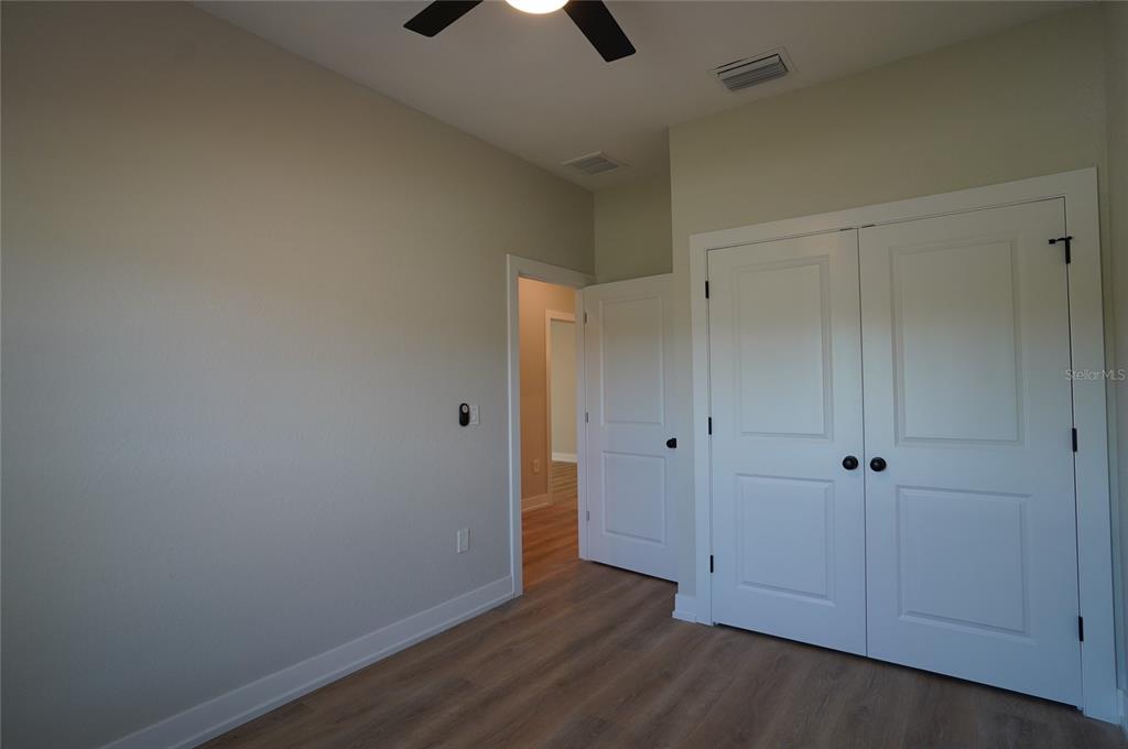 12032 Tetzel Avenue Port Charlotte, FL 33981 - Photo 10 of 32 wooden floor in an empty room
