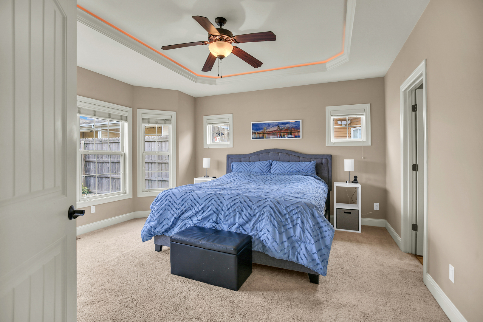 1504 Stonebluff Court, Unit 1504 Champaign, IL 61822 - Photo 13 of 23 a spacious bedroom with a large bed chandelier and a window