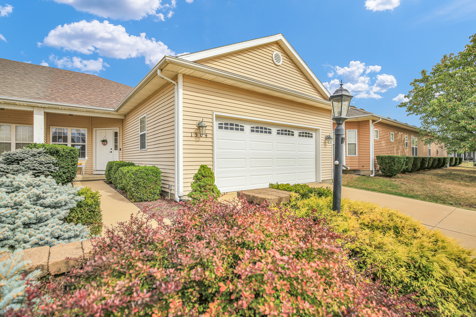 1504 Stonebluff Court, Unit 1504 Champaign, IL 61822 - Photo 2 of 23 a front view of house with yard and trees around