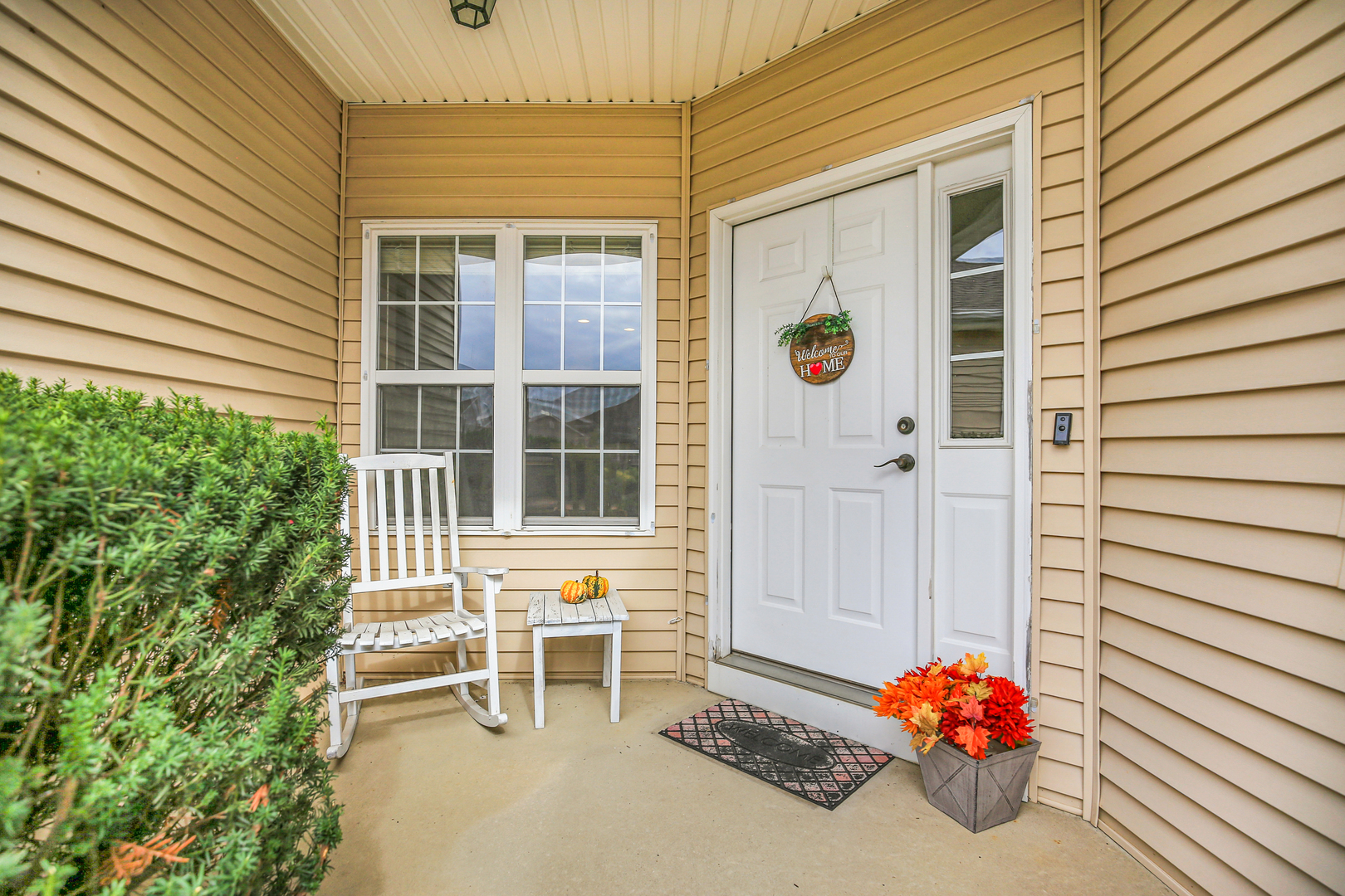 1504 Stonebluff Court, Unit 1504 Champaign, IL 61822 - Photo 4 of 23 a front view of a house with a chairs and table in a patio