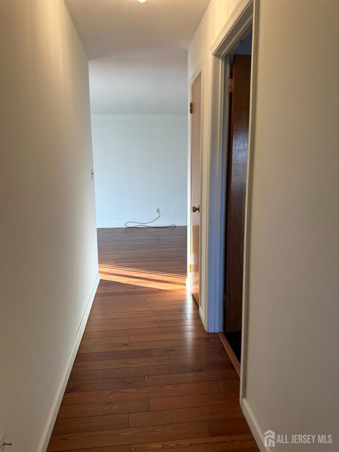111 Beverly Hl Terrace, Unit F Woodbridge, NJ 07095 - Photo 25 of 31 a view of a hallway with wooden floor