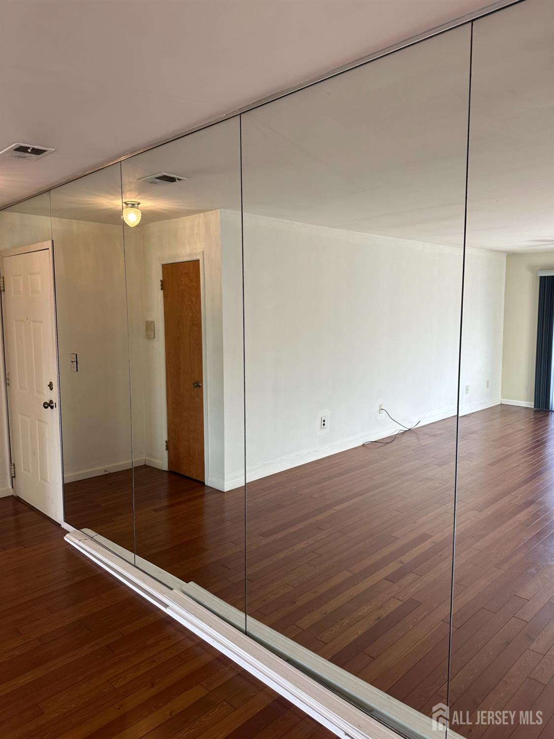 111 Beverly Hl Terrace, Unit F Woodbridge, NJ 07095 - Photo 26 of 31 a view of an empty room with wooden floor