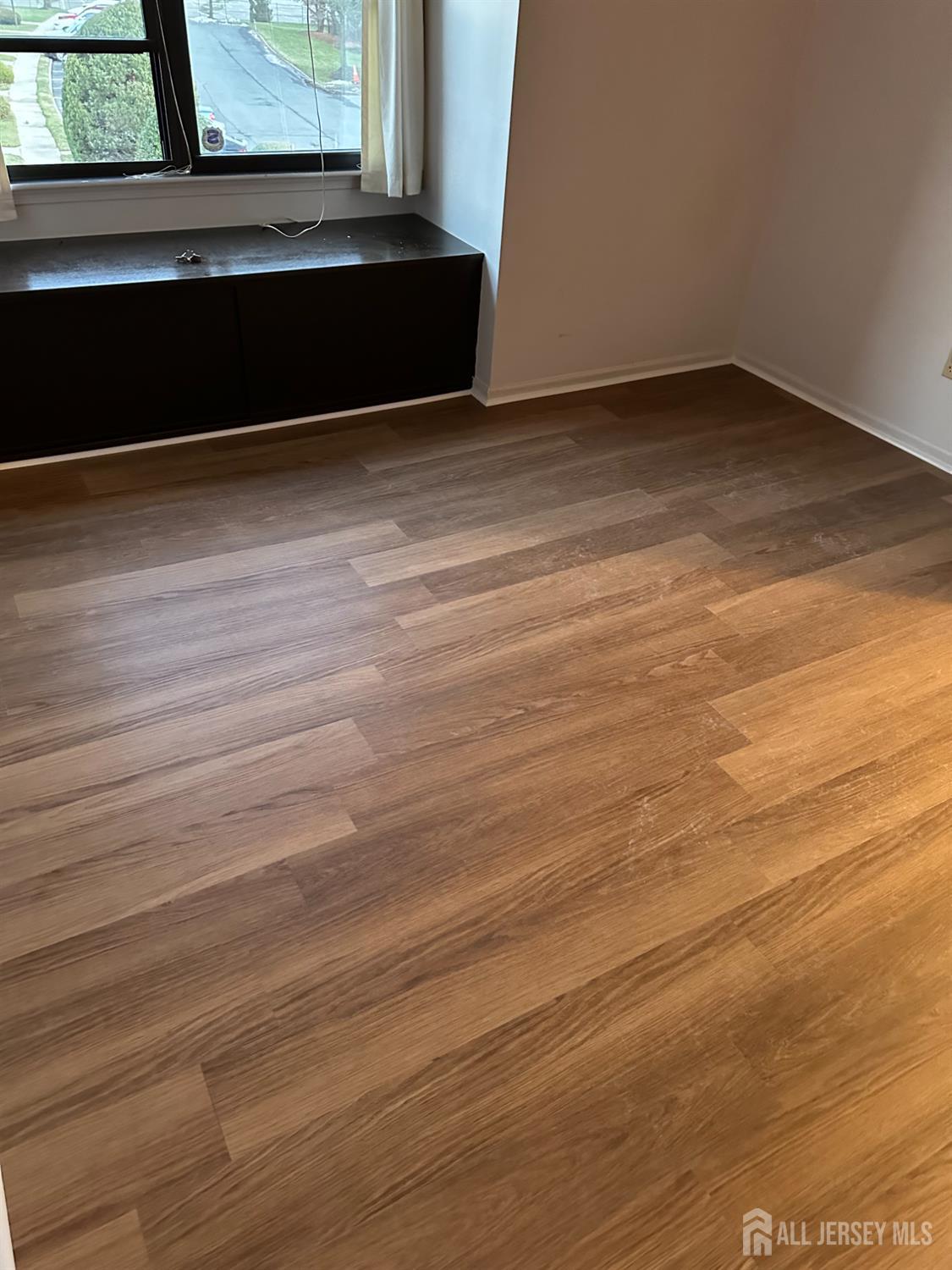 111 Beverly Hl Terrace, Unit F Woodbridge, NJ 07095 - Photo 30 of 31 a view of a room with wooden floor