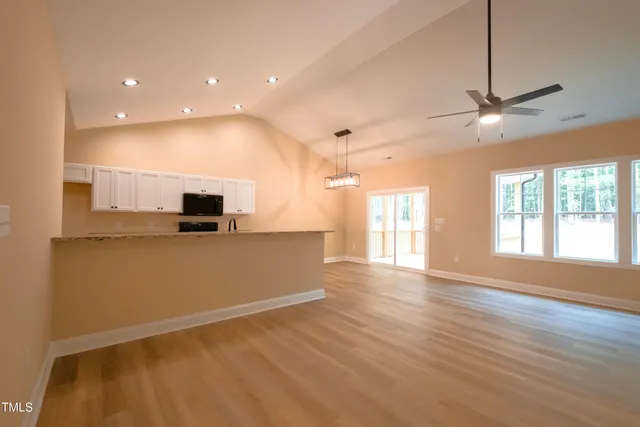 a view of a kitchen with wooden floor