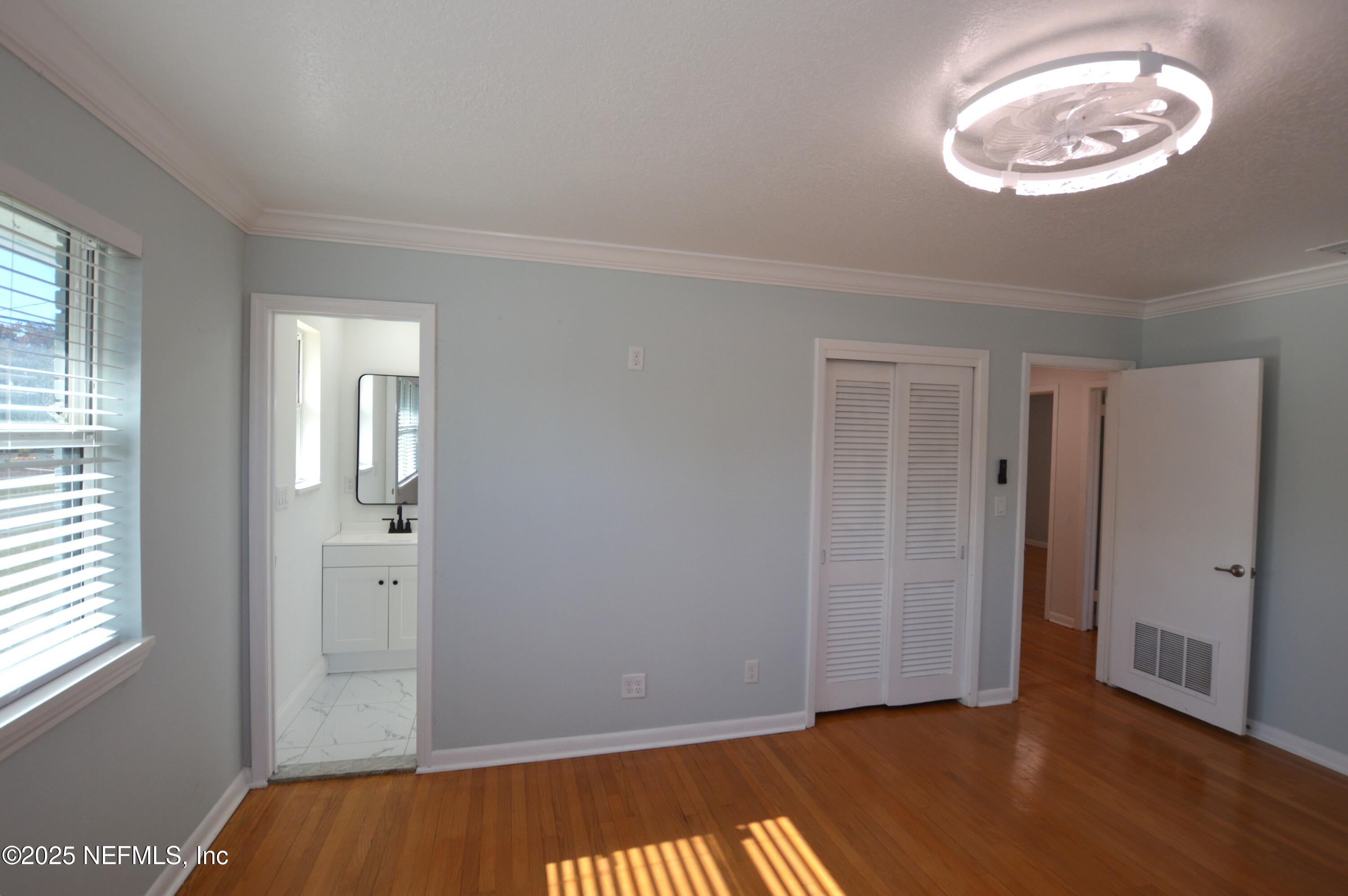 7941 Alderman Road Jacksonville, FL 32211 - Photo 17 of 40 a view of room with window and hardwood floor