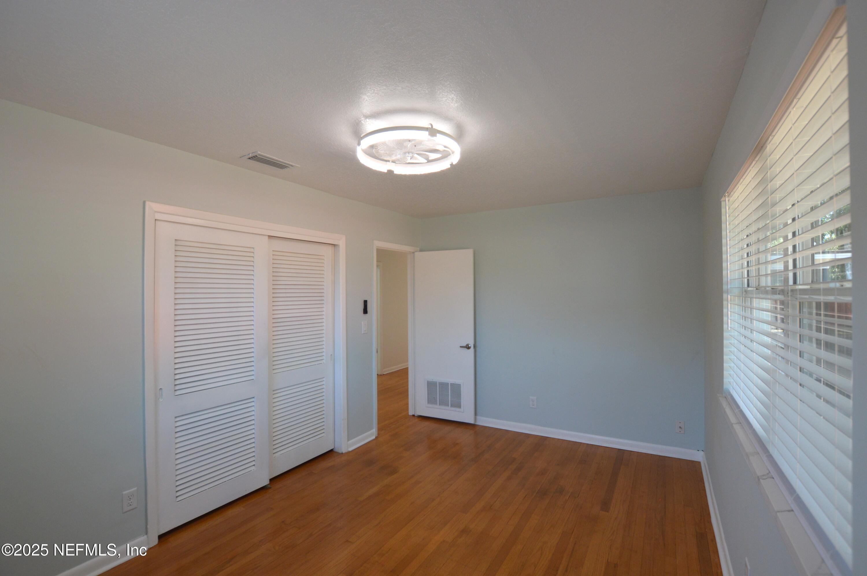 7941 Alderman Road Jacksonville, FL 32211 - Photo 20 of 40 wooden floor in an empty room with a window